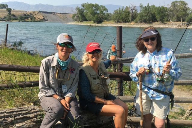 Fly fishing outing with friends on river.